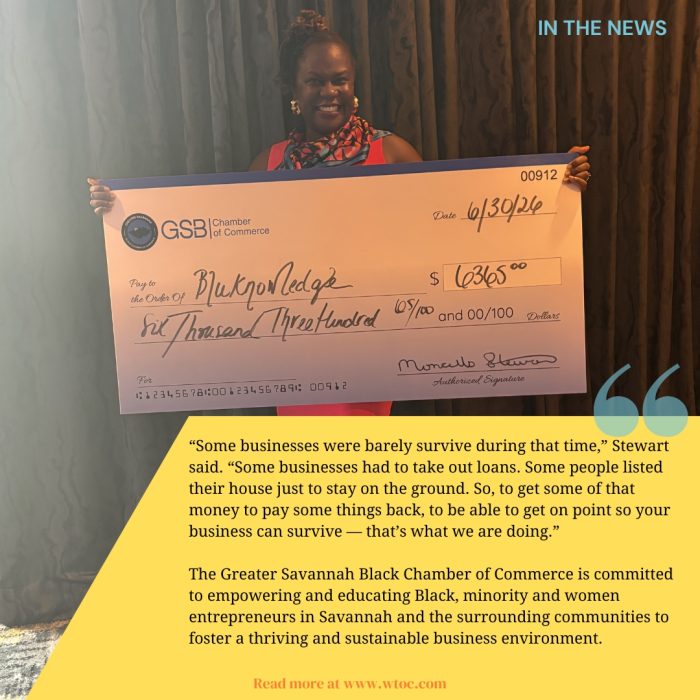 Bluknowledge representative holding a $6,365 Small Business Revitalization Grant check during the Greater Savannah Black Chamber of Commerce awards reception.